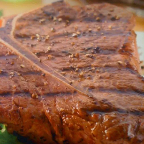 Close-up of a seasoned charcoal-grilled steak