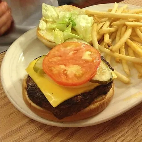 Cheeseburger with lettuce, tomato, and fries