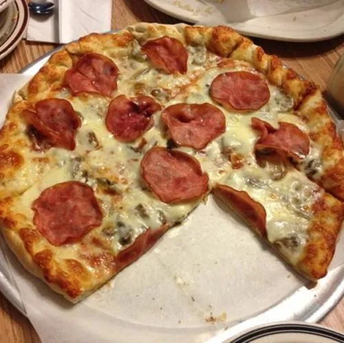 Pepperoni pizza with a slice taken out